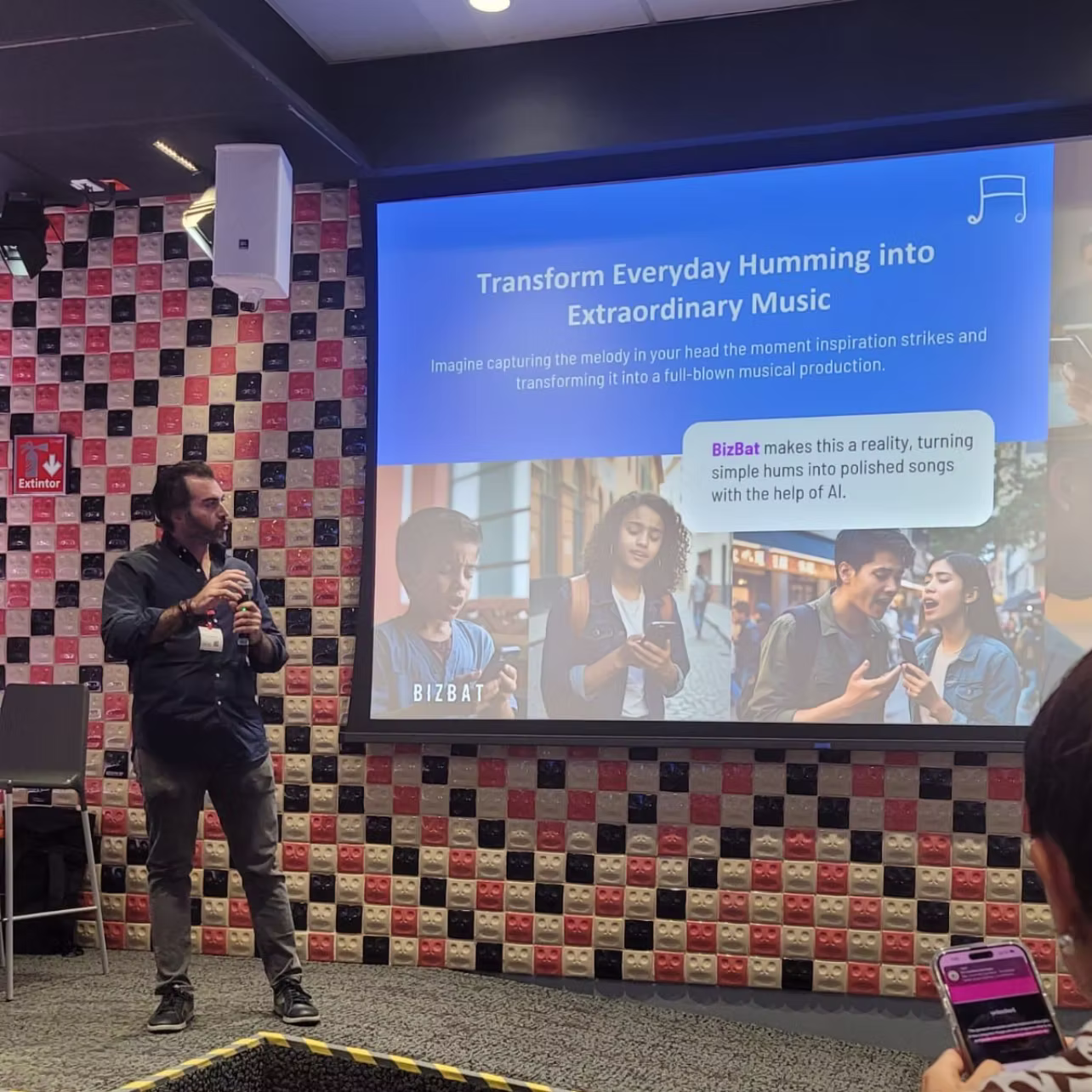 Person pitching in front of a screen detailing an AI product